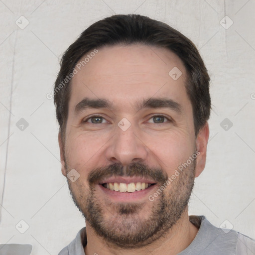 Joyful white young-adult male with short  black hair and brown eyes