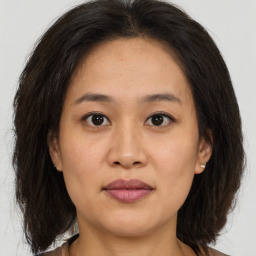 Joyful asian young-adult female with medium  brown hair and brown eyes