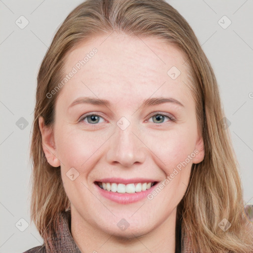 Joyful white young-adult female with long  brown hair and blue eyes