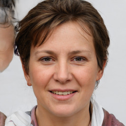 Joyful white adult female with short  brown hair and brown eyes