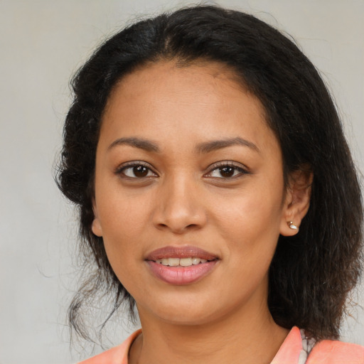 Joyful latino young-adult female with medium  brown hair and brown eyes
