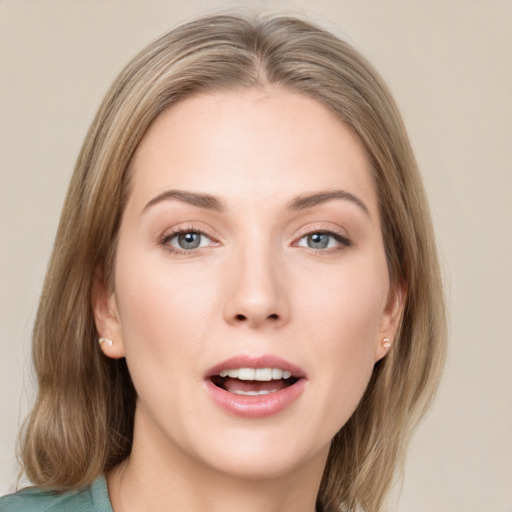 Joyful white young-adult female with medium  brown hair and green eyes