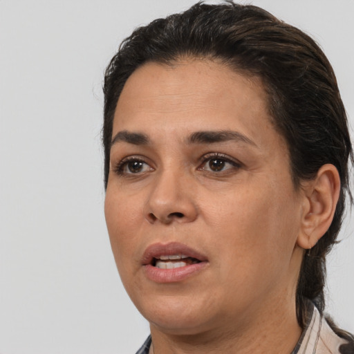Joyful white adult female with medium  black hair and brown eyes