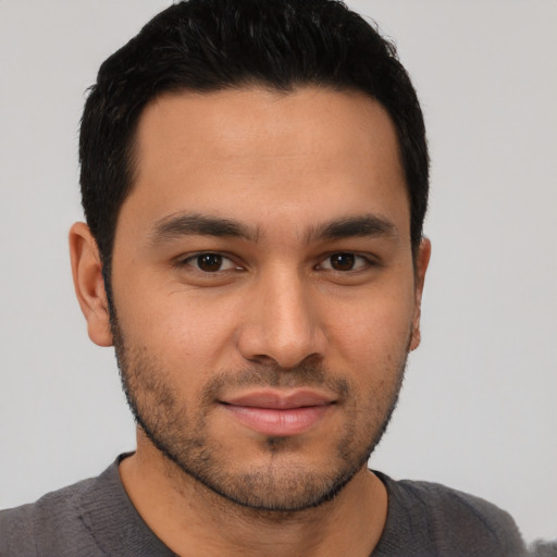 Joyful asian young-adult male with short  brown hair and brown eyes