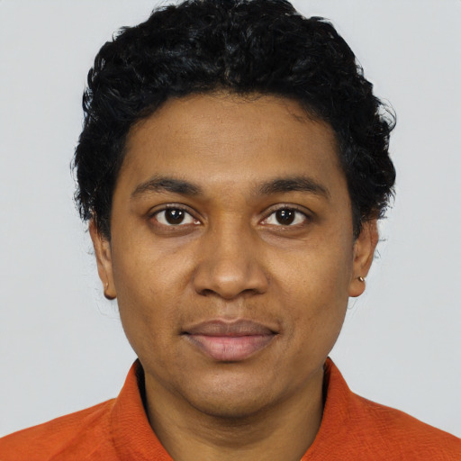 Joyful black young-adult male with short  black hair and brown eyes