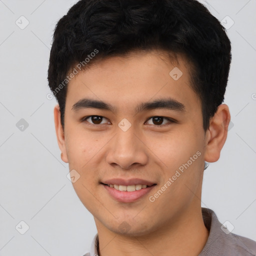 Joyful asian young-adult male with short  brown hair and brown eyes