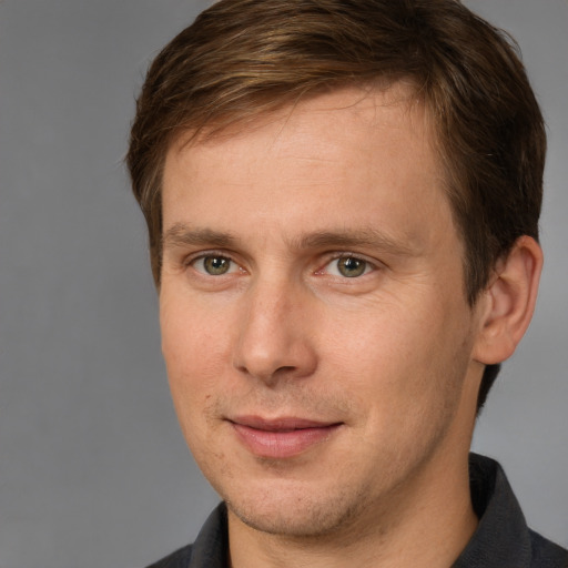 Joyful white adult male with short  brown hair and brown eyes