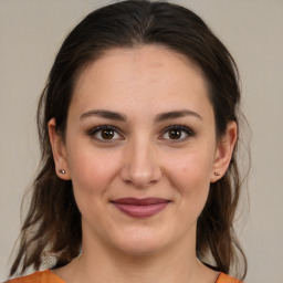 Joyful white young-adult female with medium  brown hair and brown eyes