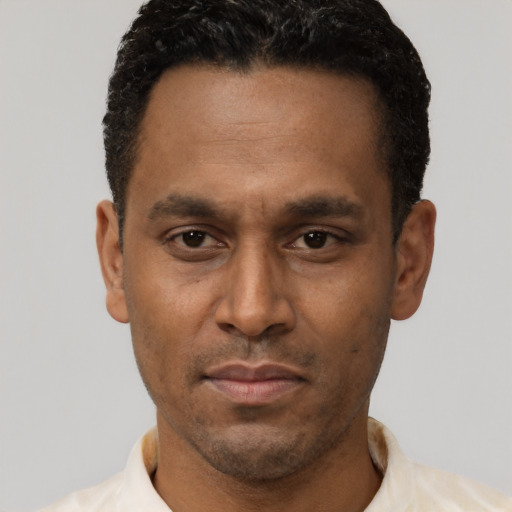 Neutral latino adult male with short  brown hair and brown eyes
