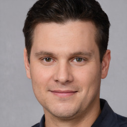 Joyful white adult male with short  brown hair and brown eyes