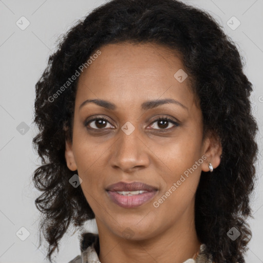 Joyful black adult female with long  brown hair and brown eyes