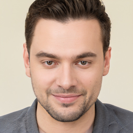 Joyful white young-adult male with short  brown hair and brown eyes