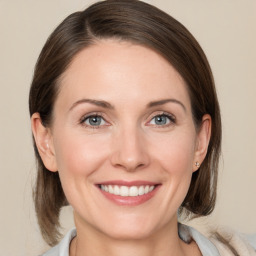 Joyful white young-adult female with medium  brown hair and grey eyes