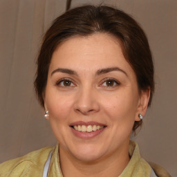 Joyful white adult female with medium  brown hair and brown eyes