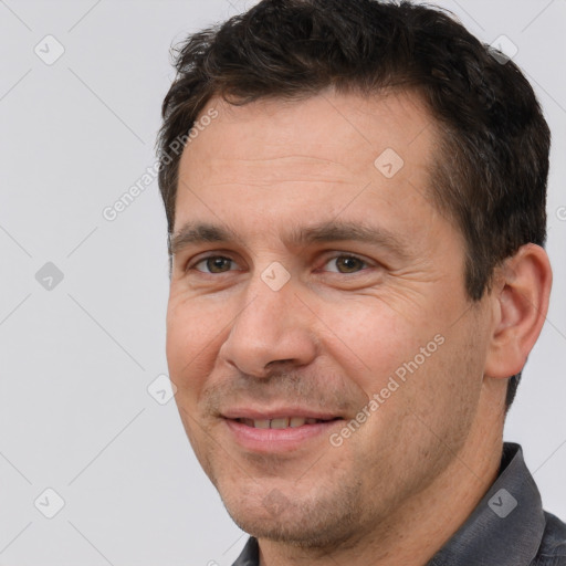 Joyful white adult male with short  brown hair and brown eyes