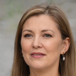 Joyful white adult female with long  brown hair and brown eyes