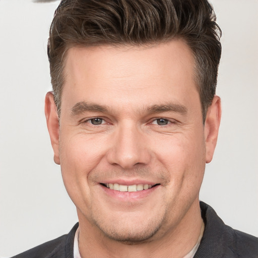 Joyful white adult male with short  brown hair and brown eyes