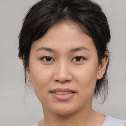 Joyful asian young-adult female with medium  brown hair and brown eyes