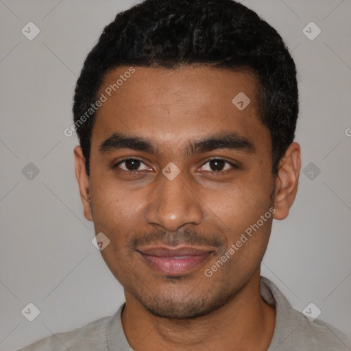 Joyful black young-adult male with short  black hair and brown eyes