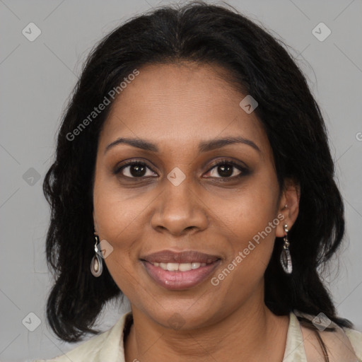 Joyful black adult female with long  brown hair and brown eyes