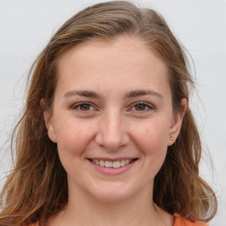 Joyful white young-adult female with long  brown hair and grey eyes