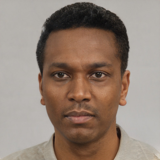 Neutral black young-adult male with short  black hair and brown eyes