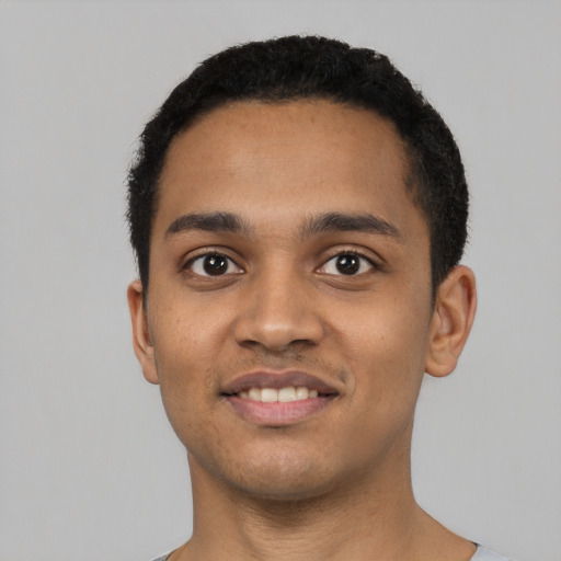 Joyful latino young-adult male with short  black hair and brown eyes