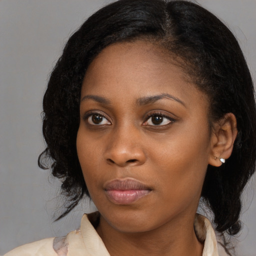 Joyful black young-adult female with medium  black hair and brown eyes