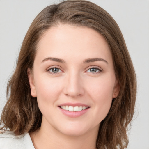 Joyful white young-adult female with medium  brown hair and green eyes