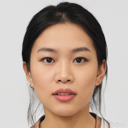 Joyful asian young-adult female with medium  black hair and brown eyes