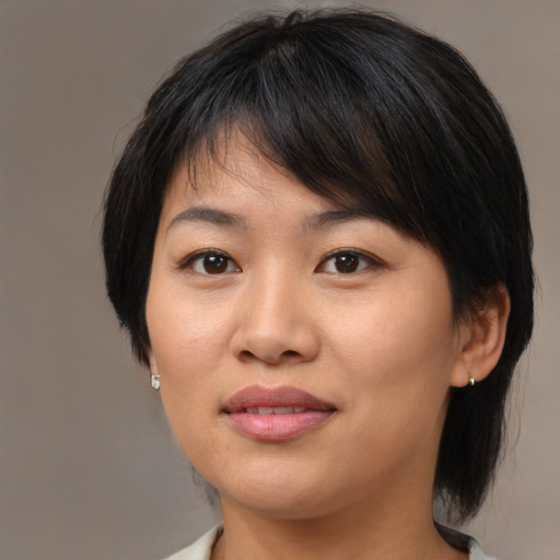 Joyful asian young-adult female with medium  brown hair and brown eyes