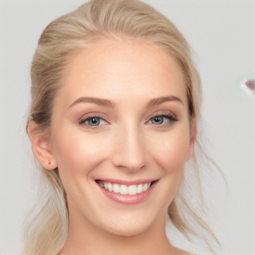 Joyful white young-adult female with medium  brown hair and blue eyes