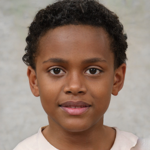 Joyful black child male with short  brown hair and brown eyes