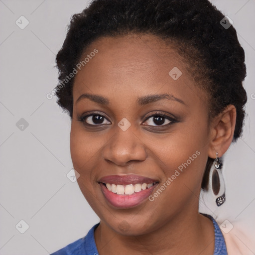 Joyful black young-adult female with short  brown hair and brown eyes