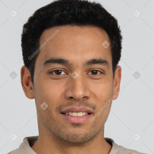 Joyful latino young-adult male with short  brown hair and brown eyes