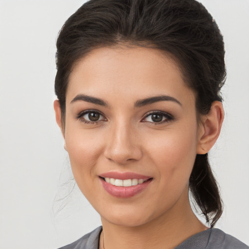 Joyful white young-adult female with long  brown hair and brown eyes