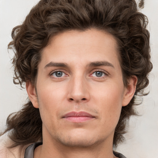 Joyful white young-adult male with medium  brown hair and brown eyes