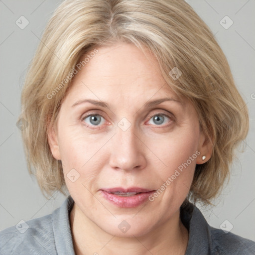 Joyful white adult female with medium  brown hair and blue eyes