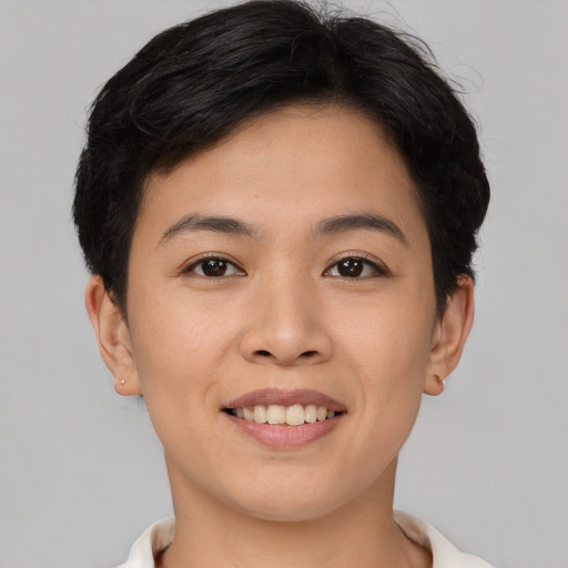 Joyful asian young-adult female with short  brown hair and brown eyes