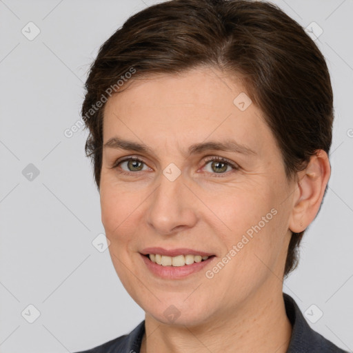 Joyful white adult female with medium  brown hair and brown eyes