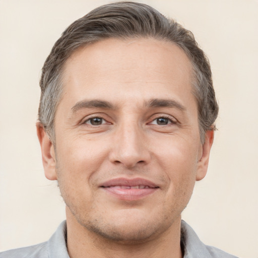 Joyful white adult male with short  brown hair and brown eyes