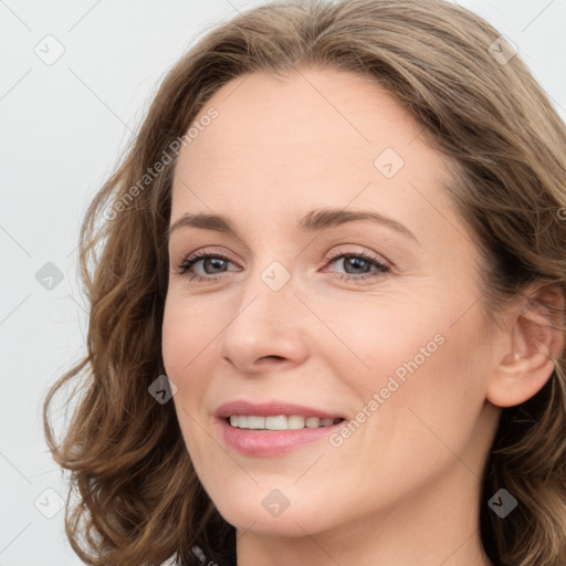 Joyful white young-adult female with long  brown hair and blue eyes