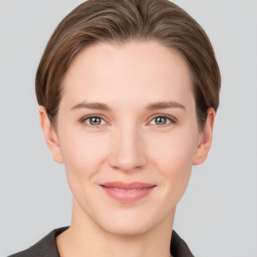 Joyful white young-adult female with short  brown hair and grey eyes