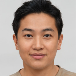 Joyful asian young-adult male with short  brown hair and brown eyes