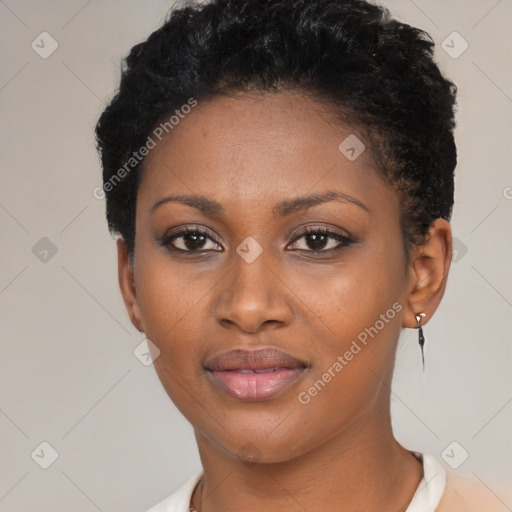 Joyful black young-adult female with short  black hair and brown eyes