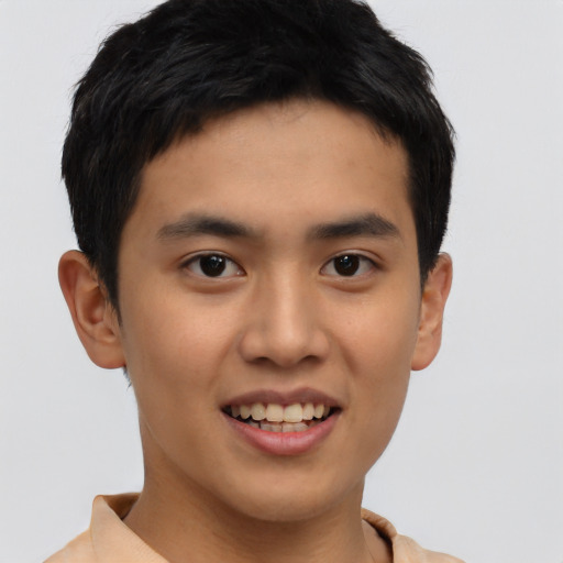 Joyful asian young-adult male with short  black hair and brown eyes