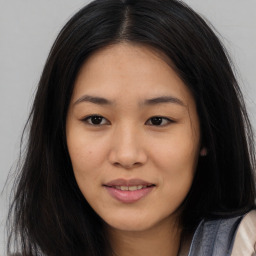 Joyful asian young-adult female with long  brown hair and brown eyes