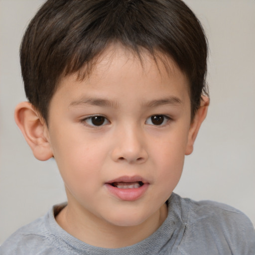 Joyful white child male with short  brown hair and brown eyes