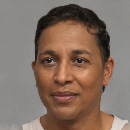 Joyful black adult male with short  brown hair and brown eyes