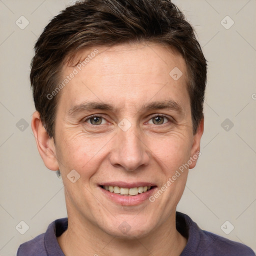 Joyful white adult male with short  brown hair and grey eyes